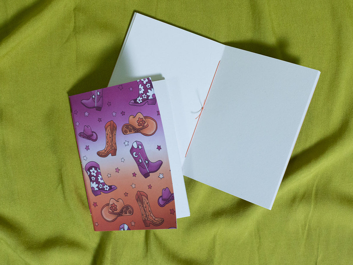 Small sketchbook with cowboy boot design on a green fabric background