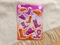 Howdy Sticker Sheet with cowboy boot and hat designs on a textured fabric background