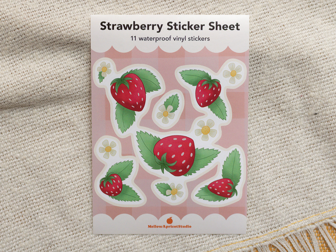 Strawberry sticker sheet on a textured fabric background