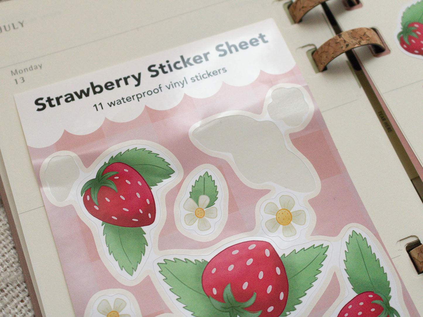 Strawberry sticker sheet with strawberries and leaves on a pink background