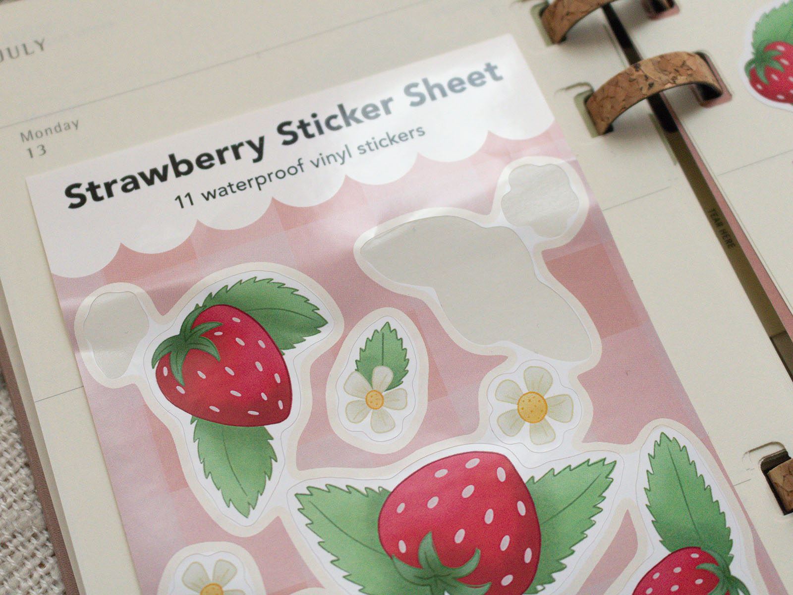 Strawberry sticker sheet with strawberries and leaves on a pink background