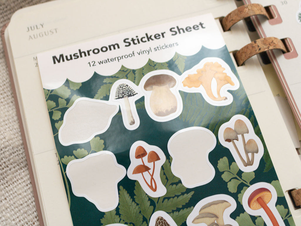 Mushroom sticker sheet with 12 waterproof vinyl stickers on a planner.
